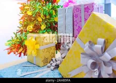 Beautiful various gifts boxes or presents in different size and shape with ribbon on table in the party Stock Photo