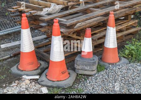 Collection of four road cones separating off an area from pedestrian access on a building site. Stock Photo