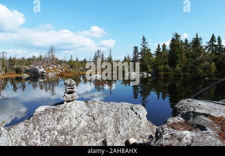 Swamp or lake with megalithic seid boulder stones, dead trees in nature reserve on mountain Vottovaara, Karelia, Russia. Natural background view. Lapp Stock Photo