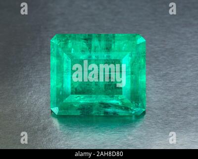 big natural emerald on a gray background, included clipping path extreme close up. Stock Photo