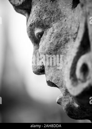 Black and white close up of the screaming head of a marble statue Stock Photo