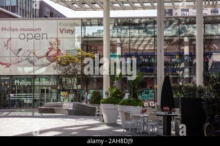 Eindhoven, Netherlands. October 10, 2019. The glass entrance of Philips Museum. The poster inform the visitors that the audio exhibition is open. Stock Photo