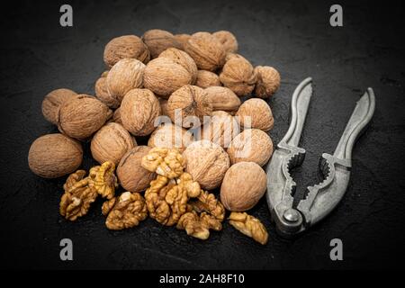 Walnut on over black slate stone background Stock Photo
