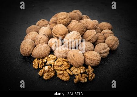 Walnuts on black background. Group walnuts on Healthy organic food concept. Stock Photo