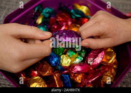 Fighting over favourite quality street chocolates Stock Photo