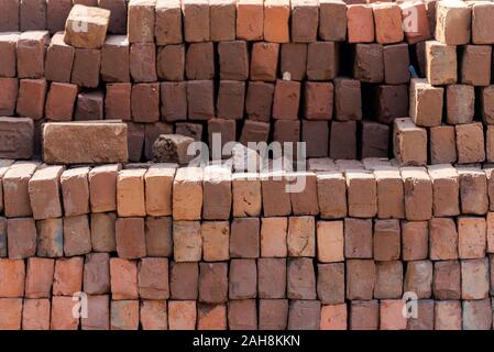 Stacked red bricks ready to use for construction Stock Photo