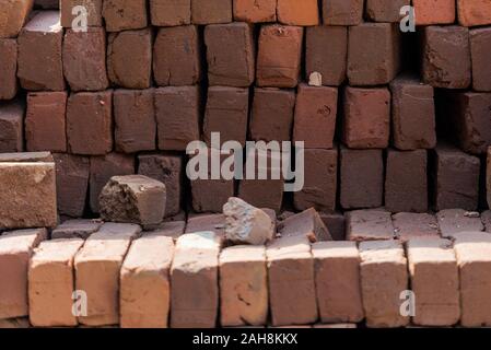 Stacked red bricks ready to use for construction Stock Photo