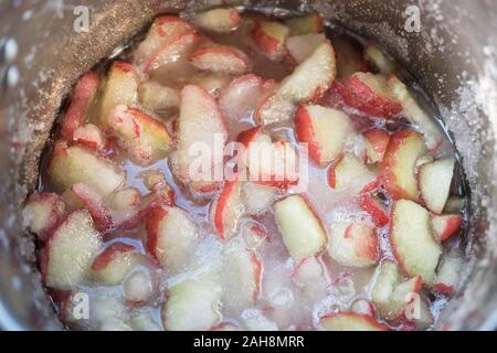 Java apple chunks, sugar and syrup in a pan, ready for being boiled. Cooking java apple jam. The fruit is also known as Semarang rose apple Stock Photo