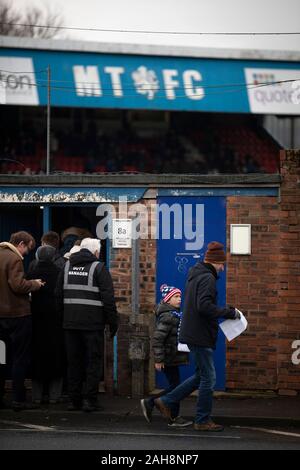 Spectators arriving outside the ground before Macclesfield Town played Grimsby Town in a SkyBet League 2 fixture at Moss Rose. The home club had suffered problems in the run up to this fixture with the EFL deducting points after they failed to pay staff and they had a game postponed. This match ended in a 1-1 draw, watched by a crowd of 1,991. Stock Photo