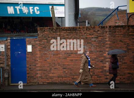 Spectators arriving outside the ground before Macclesfield Town played Grimsby Town in a SkyBet League 2 fixture at Moss Rose. The home club had suffered problems in the run up to this fixture with the EFL deducting points after they failed to pay staff and they had a game postponed. This match ended in a 1-1 draw, watched by a crowd of 1,991. Stock Photo