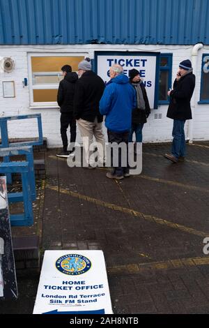 Spectators arriving outside the ground before Macclesfield Town played Grimsby Town in a SkyBet League 2 fixture at Moss Rose. The home club had suffered problems in the run up to this fixture with the EFL deducting points after they failed to pay staff and they had a game postponed. This match ended in a 1-1 draw, watched by a crowd of 1,991. Stock Photo