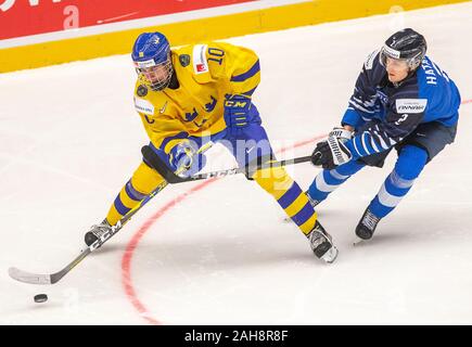 Trinec, Czech Republic. 26th Dec, 2019. L-R Alexander Holtz (SWE) and Santeri Hatakka (FIN) in action during the 2020 IIHF World Junior Ice Hockey Championships Group A match between Sweden and Finland in Trinec, Czech Republic, on December 26, 2019. Credit: Vladimir Prycek/CTK Photo/Alamy Live News Stock Photo