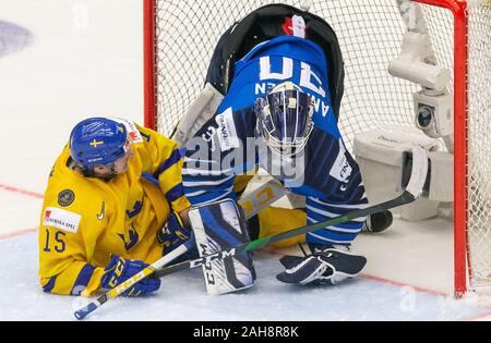 Trinec, Czech Republic. 26th Dec, 2019. L-R Oskar Back (SWE) and goalkeeper Justus Annunen in action during the 2020 IIHF World Junior Ice Hockey Championships Group A match between Sweden and Finland in Trinec, Czech Republic, on December 26, 2019. Credit: Vladimir Prycek/CTK Photo/Alamy Live News Stock Photo