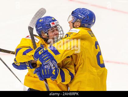 Trinec, Czech Republic. 26th Dec, 2019. L-R Swedish players Alexander Holtz and Jonatan Berggren celebrate victory in the 2020 IIHF World Junior Ice Hockey Championships Group A match between Sweden and Finland in Trinec, Czech Republic, on December 26, 2019. Credit: Vladimir Prycek/CTK Photo/Alamy Live News Stock Photo