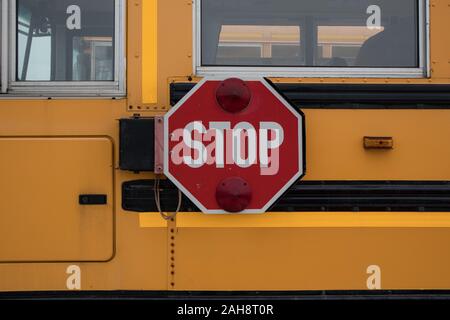 The side of a school bus, the stop sign not in use. Stock Photo