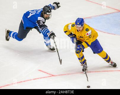 Trinec, Czech Republic. 26th Dec, 2019. L-R Aatu Raty (FIN) and Jonathan Berggren (SWE) in action during the 2020 IIHF World Junior Ice Hockey Championships Group A match between Sweden and Finland in Trinec, Czech Republic, on December 26, 2019. Credit: Vladimir Prycek/CTK Photo/Alamy Live News Stock Photo