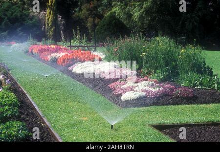 AUTOMATIC WATERING SYSTEM WATERS GARDEN BEDS AND LAWN Stock Photo