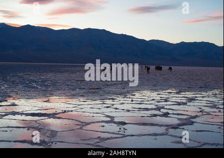 Photographers gathering at Badwater Basin in Death Valley National Park to photograph the colourful sunset over the flooded saltflats on 14 Dec 2019 Stock Photo