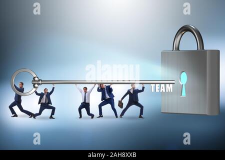 The concept of teamwork with businessmen unlocking lock Stock Photo