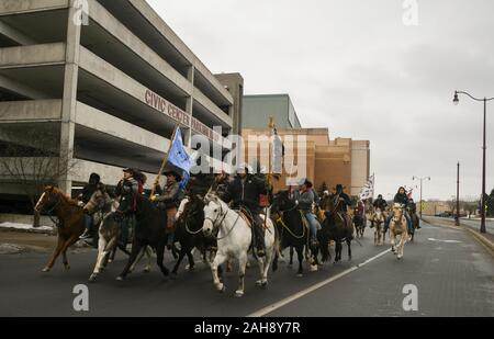 Mankato, Minnesota, USA. 26th Dec, 2019. Dakota Indians arrive in downtown Mankato, MN, site of the largest mass execution in US history, and the final stop on their annual 18-day, 325-mile ride on horseback to remember the hanging of 39 Dakotas ''” and later, two chiefs''” 157 years from today, who rose up after the US government betrayed their treaties, failed to send promised rations, and white settlers refused to sell the starving Indians food. Credit: Miguel Juarez Lugo/ZUMA Wire/Alamy Live News Stock Photo