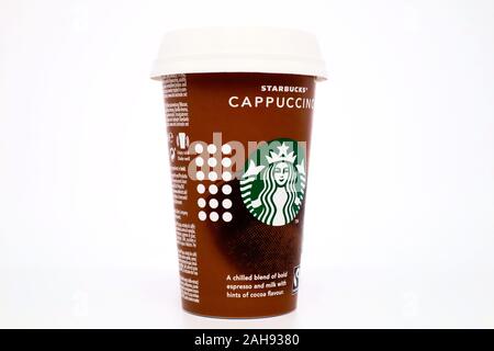 Starbucks Cappuccino cup with straw. Starbucks is an American coffee company and coffee house chain Stock Photo