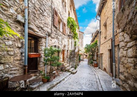 A picturesque back street of homes and apartments in the medieval village of Tourrettes Sur Loup in the Alpes Maritimes area of Southern France. Stock Photo