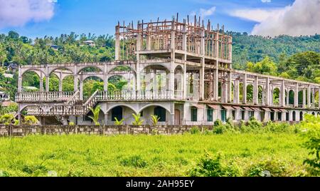 A failed tourism project in the Philippines, resulting in an abandoned hotel construction site in a former rice paddy, after the owner ran out of cash Stock Photo