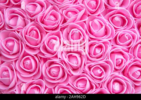 Floral background. Lot of artificial flowers in colorful composition. lots of pink roses. Rose texture Stock Photo