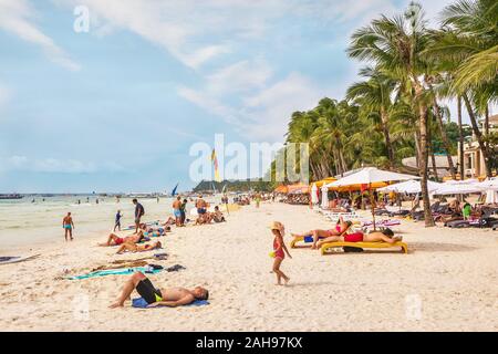 Boracay Island, Philippines - January 6, 2017. Tourists enjoying White Beach, Boracay in good weather. Stock Photo