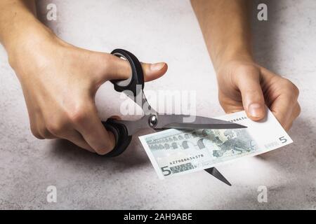 A man cuts the euro. Concept on the topic of devaluation of money in the country Stock Photo