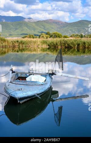 A small fishingboat on Mikri Prespa lake at the village of Mikrolimni in Macedonia, Northern Greece. Stock Photo