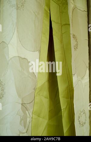 At a textile, fabric stall, plenty of styles from which to choose. Here, various shades of green. In Tawau, Sabah, Borneo, Malaysia. Stock Photo
