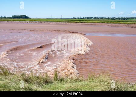 Tidal wave flows twice a day against the Petitcodiac River, Moncton, New Brunswick, Canada Stock Photo