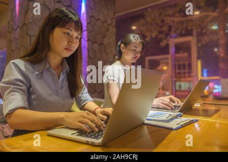 Two office employees working late in office Stock Photo