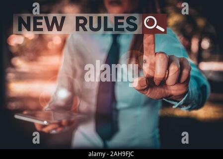 Word writing text New Rules. Business photo showcasing recently one of a set of explicit or understood regulations Handsome business girl pointing wit