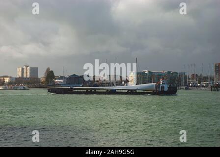 Blades for wind turbines being transported to an offshore windfarm Stock Photo