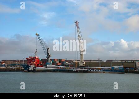 Blades for wind turbines being transported to an offshore windfarm Stock Photo