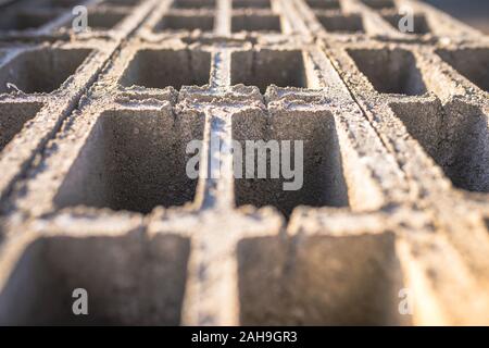 Concrete block bricks in stack for wall construction. Concrete block, cinder blocks, breeze blocks, hollow blocks, Besser blocks or Besser bricks wall Stock Photo