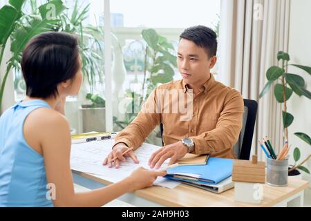 Two architects discussing about new project in the office Stock Photo