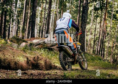 motocross rider riding forest trail. spray of dirt rear wheel Stock Photo