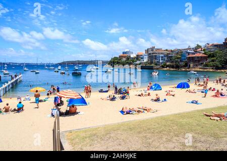 Sydney, Australia - December 28th 2013: People sunbathing and enjoying Little Manly beach. This is one of the citys Northern Beaches. Stock Photo