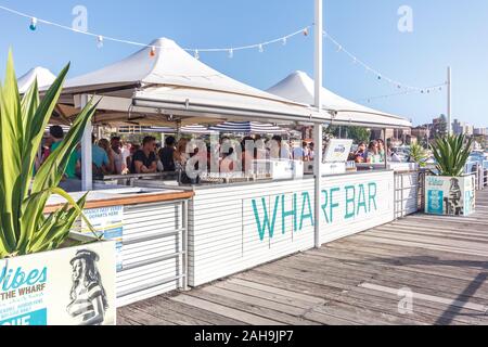 Sydney, Australia - December 30th 2013: People drinking in the Wharf Bay in Manly. The bar is popular on hot sunny days. Stock Photo