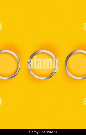 Repair concept. Yellow background with three paint cans. Flat lay, top view, copy space. Stock Photo