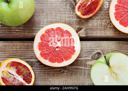 Mix of fresh sliced fruits on a wooden background. Photo with depth of field. Stock Photo