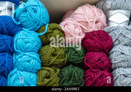 Pink, gray, multicolored yarn of wool in bundles for hand knitting