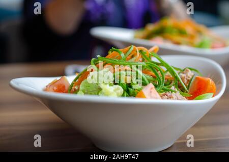 Tuna salad with carrots, salad, tomatoes, parsley, seasonal greens, healthy eating and diet concept Stock Photo