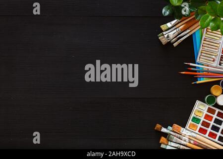 Creative art painting drawing supplies tools set on wooden desk top view Stock Photo