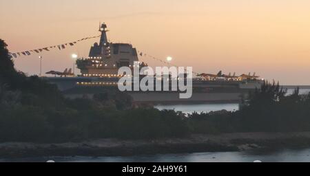 Sanya. 18th Dec, 2019. Photo taken on Dec. 18, 2019 shows the Shandong aircraft carrier at a naval port in Sanya, south China's Hainan Province. China's first domestically built aircraft carrier, the Shandong, was delivered to the People's Liberation Army (PLA) Navy and placed in active service on Dec. 17 at a naval port in Sanya. The new aircraft carrier, named after Shandong Province in east China, was given the hull number 17. Credit: Li Gang/Xinhua/Alamy Live News Stock Photo