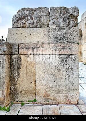 Ancient stone wall of the Acropolis, Athens, Attica region in Greece. Huge antique blocks of stone piled up to form a wall. Photo. Stock Photo