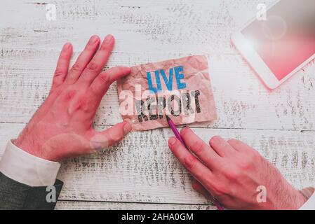 Conceptual hand writing showing Live Report. Concept meaning continuous stream of updates that are published in real time Hand hold note paper near wr Stock Photo